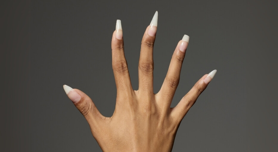 mão de mulher com unhas em fibra de vidro de diferentes formatos