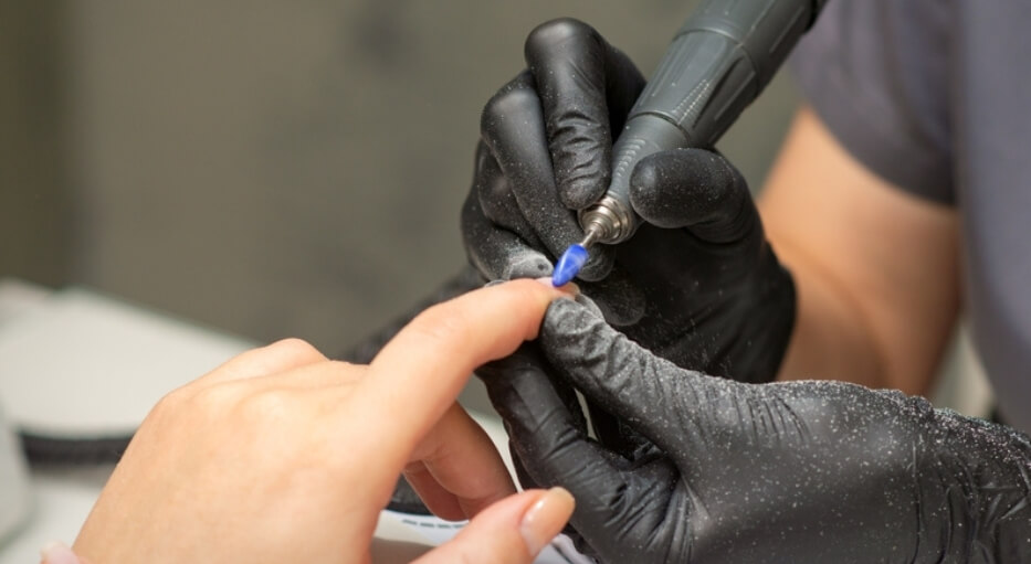 manicure removendo a unha de fibra de vidro da unha